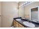 Bathroom featuring double vanity, tile floors, and a shower/tub combo at 4451 S Ammons St # 1-304, Littleton, CO 80123