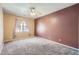 Bedroom featuring large window, ceiling fan, and neutral color walls at 4451 S Ammons St # 1-304, Littleton, CO 80123
