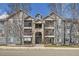 Beautiful condo complex with blue siding, well-maintained landscaping and a welcoming entrance at 4451 S Ammons St # 1-304, Littleton, CO 80123