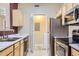 Updated kitchen featuring stainless steel appliances, marble counter tops and adjacent laundry room at 4451 S Ammons St # 1-304, Littleton, CO 80123
