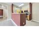 View of kitchen from living area with breakfast bar, stainless steel appliances and hardwood flooring at 4451 S Ammons St # 1-304, Littleton, CO 80123