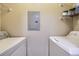 Laundry room featuring a circuit breaker, metal shelving, a dryer, and a washing machine at 4451 S Ammons St # 1-304, Littleton, CO 80123