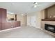 Spacious living room with fireplace, white floors, open to kitchen and neutral paint throughout at 4451 S Ammons St # 1-304, Littleton, CO 80123