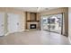 Light-filled living room featuring a fireplace, sliding door to balcony, and neutral wall color at 4451 S Ammons St # 1-304, Littleton, CO 80123