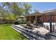 Outdoor back deck featuring a seating area, a grill, lounge chairs, a hot tub, and plenty of space for entertaining at 1196 S Quebec Way, Denver, CO 80231