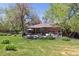 Spacious backyard with lush greenery, a patio, and a barbecue area, perfect for outdoor entertaining at 1196 S Quebec Way, Denver, CO 80231