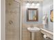 Bright bathroom featuring a glass shower, pedestal sink, and coordinated fixtures for a clean, modern feel at 1196 S Quebec Way, Denver, CO 80231