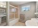 Bathroom featuring a shower, pedestal sink, and tile floors at 1196 S Quebec Way, Denver, CO 80231
