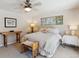 Bright bedroom features a comfortable bed, side tables, and a window, creating a relaxing atmosphere at 1196 S Quebec Way, Denver, CO 80231