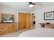 Comfortable bedroom with wooden dresser and closet perfect for storage and organization at 1196 S Quebec Way, Denver, CO 80231