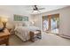 Cozy bedroom boasts natural light, a ceiling fan, and access to an outdoor patio for relaxation at 1196 S Quebec Way, Denver, CO 80231