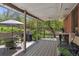 Covered backyard deck featuring a barbecue grill and ample seating, great for enjoying outdoor meals and gatherings at 1196 S Quebec Way, Denver, CO 80231