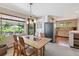 Dining room featuring a wood table and chairs and open view to kitchen at 1196 S Quebec Way, Denver, CO 80231