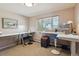 Bright home office featuring multiple work stations, large windows and neutral paint color at 1196 S Quebec Way, Denver, CO 80231