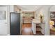 Functional kitchen offering a stainless refrigerator, tile countertops, and ample storage space for modern convenience at 1196 S Quebec Way, Denver, CO 80231