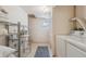 Functional laundry room equipped with shelving, washer and dryer, plus a small window at 1196 S Quebec Way, Denver, CO 80231