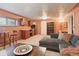 Open living room with a sofa, built-in cabinets, bar seating and natural light from the window at 1196 S Quebec Way, Denver, CO 80231