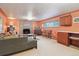 Cozy living room featuring a stone fireplace, neutral carpet, and comfortable seating at 1196 S Quebec Way, Denver, CO 80231