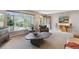 Bright and airy living room featuring unique furnishings and a large view window at 1196 S Quebec Way, Denver, CO 80231