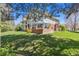 Lush backyard featuring a patio area, mature trees, and manicured lawn at 3 Winged Foot Way, Littleton, CO 80123