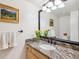 Well-lit bathroom featuring granite countertops and a large mirror at 3 Winged Foot Way, Littleton, CO 80123