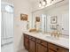 Spacious bathroom with dual vanities, quartz countertops, and elegant gold fixtures at 3 Winged Foot Way, Littleton, CO 80123