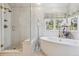 Bright bathroom featuring a soaking tub, walk-in shower, and stylish fixtures at 3 Winged Foot Way, Littleton, CO 80123