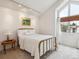 Bright bedroom featuring a brass bed frame, large window, and neutral tones at 3 Winged Foot Way, Littleton, CO 80123