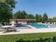 Community pool area featuring a large pool, sun loungers, tables and a covered structure at 3 Winged Foot Way, Littleton, CO 80123
