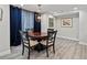 Modern dining room area featuring a round table and dramatic blue curtains at 3 Winged Foot Way, Littleton, CO 80123