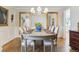 Elegant dining room with hardwood floors, modern chandelier, and neutral decor at 3 Winged Foot Way, Littleton, CO 80123
