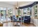 Inviting dining room with glass table and blue accents, bathed in natural light at 3 Winged Foot Way, Littleton, CO 80123