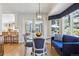 Bright dining area with a glass-top table, a sofa, and views of the backyard at 3 Winged Foot Way, Littleton, CO 80123