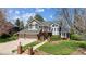 Charming two-story home boasts a manicured lawn, two-car garage, and brick accents at 3 Winged Foot Way, Littleton, CO 80123