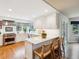 Bright kitchen boasts stainless steel appliances, white cabinets, and an island with bar seating at 3 Winged Foot Way, Littleton, CO 80123