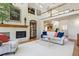 Comfortable living room with fireplace, brick accent wall, and modern decor at 3 Winged Foot Way, Littleton, CO 80123