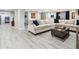 Spacious living room featuring light wood floors and a comfortable sectional sofa at 3 Winged Foot Way, Littleton, CO 80123