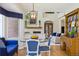 Elegant living room with exposed brick, opening to dining area with a fireplace at 3 Winged Foot Way, Littleton, CO 80123