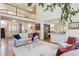Bright living room with soaring ceilings, white sofa, and an open floor plan at 3 Winged Foot Way, Littleton, CO 80123