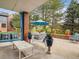 Covered patio with comfortable seating and views of the manicured backyard at 3 Winged Foot Way, Littleton, CO 80123