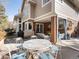 Spacious covered patio with dining and lounge areas for outdoor entertaining at 3 Winged Foot Way, Littleton, CO 80123