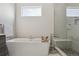 Relaxing bathroom featuring a standalone tub, glass-enclosed shower, and modern fixtures at 2862 E 103Rd Ave, Denver, CO 80229