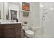 Modern bathroom featuring a glass-enclosed shower with a built-in bench and stylish vanity at 2862 E 103Rd Ave, Denver, CO 80229