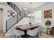 Bright dining area features modern chandelier, stylish staircase, and contemporary decor at 2862 E 103Rd Ave, Denver, CO 80229
