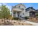 Charming two-story home featuring a cozy front porch and well-maintained landscaping at 2862 E 103Rd Ave, Denver, CO 80229