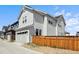 Charming home with a light gray exterior, two-car garage, and a wooden privacy fence at 2862 E 103Rd Ave, Denver, CO 80229