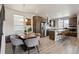Modern kitchen and dining area with stainless steel appliances and sleek wooden cabinets at 2862 E 103Rd Ave, Denver, CO 80229