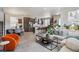 Open-concept living space with modern decor and large windows, creating a bright and airy atmosphere at 2862 E 103Rd Ave, Denver, CO 80229