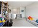 Open loft area with stylish shelving, comfortable seating, and a view of the staircase at 2862 E 103Rd Ave, Denver, CO 80229