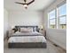 Cozy main bedroom featuring a ceiling fan, plush bedding, and great natural light at 2862 E 103Rd Ave, Denver, CO 80229